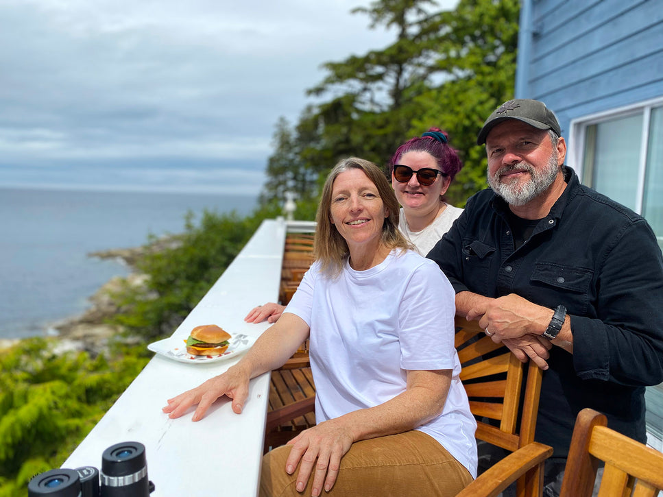 three people enjoying lunch on malei islands outdoor patio