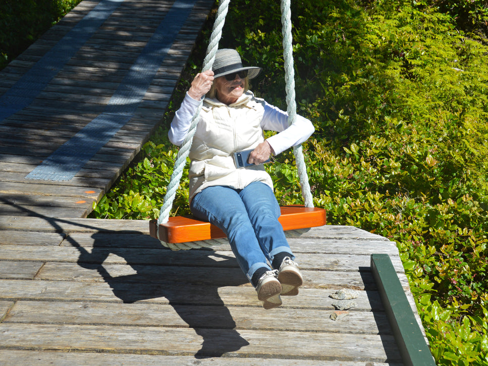 senior relaxing on wood swing at malei island