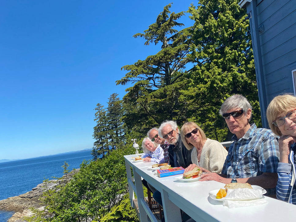 seniors eating lunch at an outdoor bar overlooking the ocean
